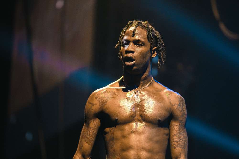 Travis Scott Gets Inked With a Tiger Tattoo in Eerie ‘DUMBO’ Video: Watch