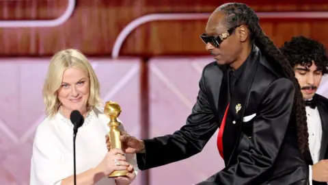 Snoop Dogg Presents Amy Poehler With Inaugural Best Podcast Award at 2026 Golden Globes: ‘This Is Exactly How I Pictured It’